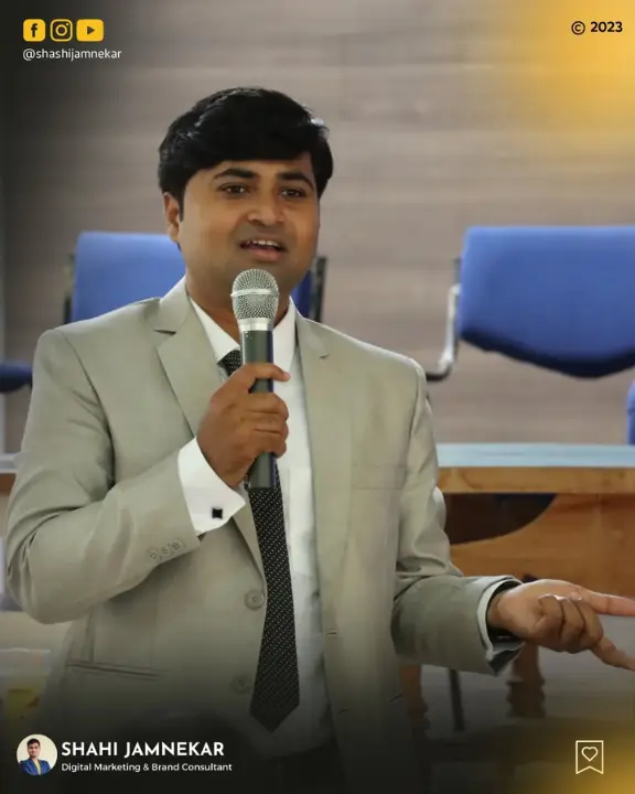 A professional close-up of keynote speaker Shashi Jamnekar, Digital Marketing & Brand Consultant, delivering a speech into a microphone at a conference.