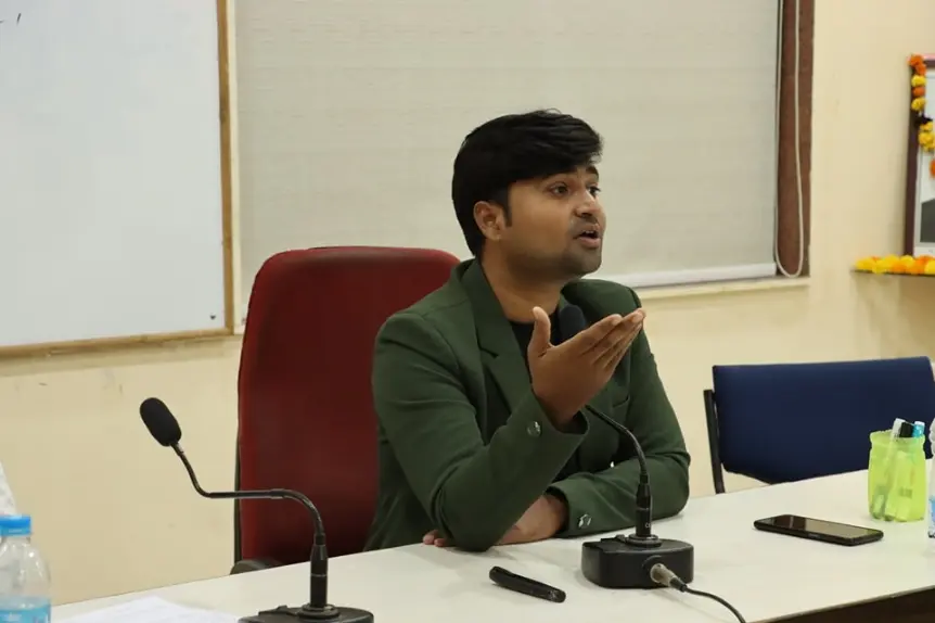 Digital marketing consultant Shashi Jamnekar speaking passionately during a corporate training session in Kolhapur, gesturing to emphasize a point at a conference table.
